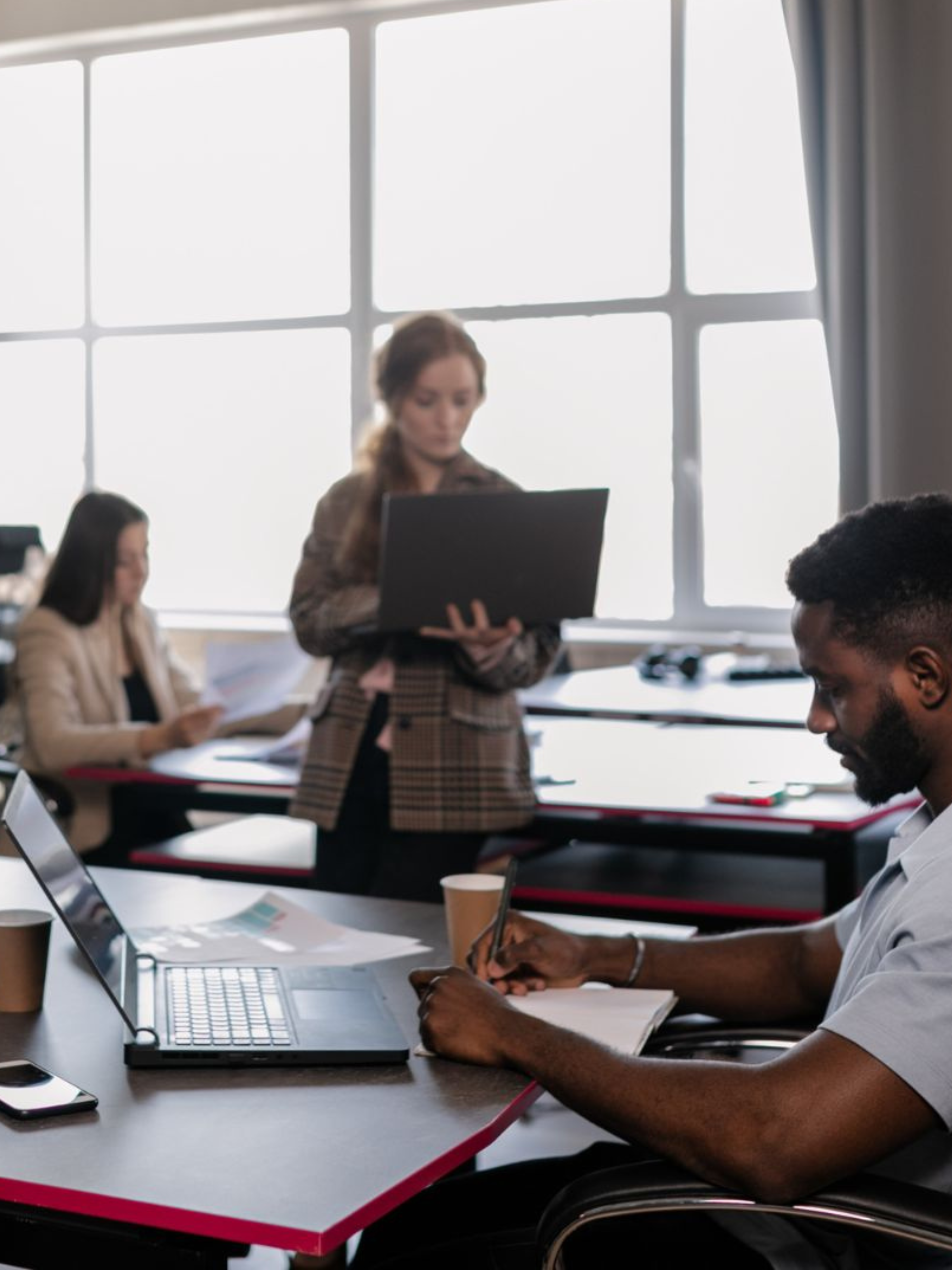 Image of three people working