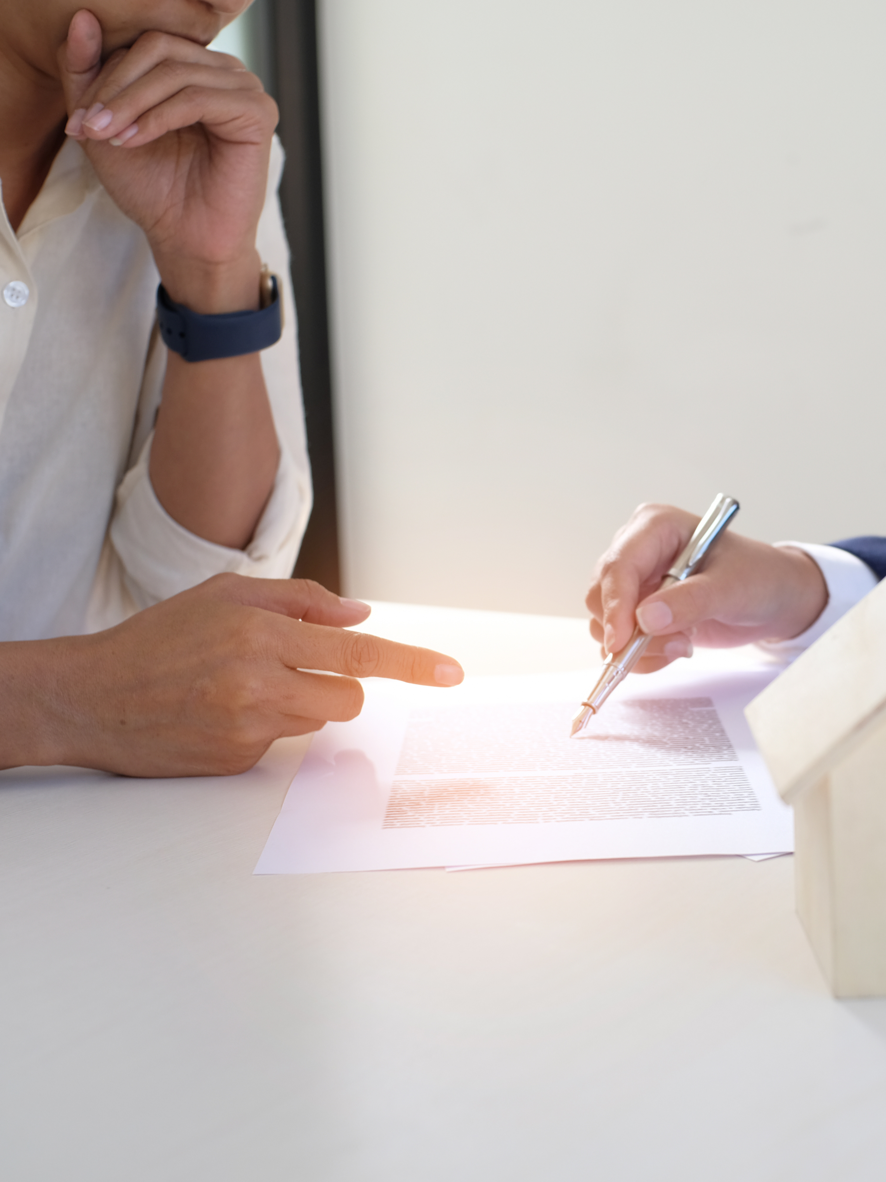 Image of a person listening to another person explain something on the paper