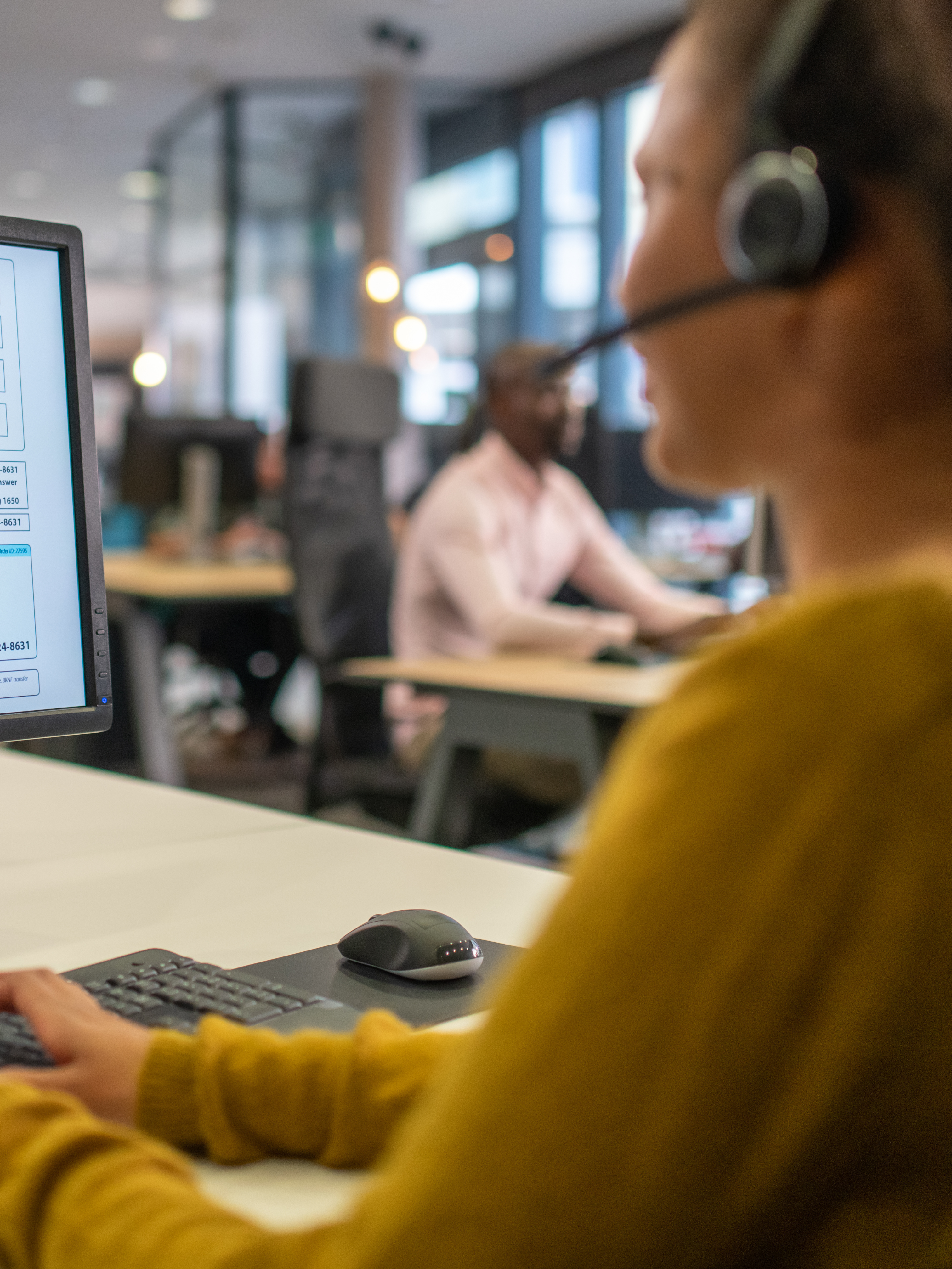 person on the computer with a headset with a microphone